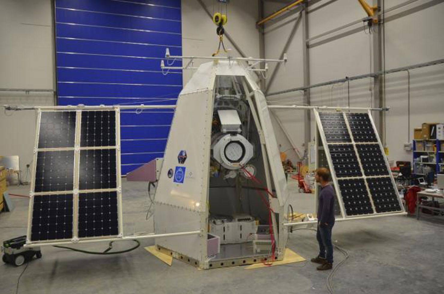 The PoGOLite gondola in 2012 configuration. MSc student Hadrien Verbios checks on progress.